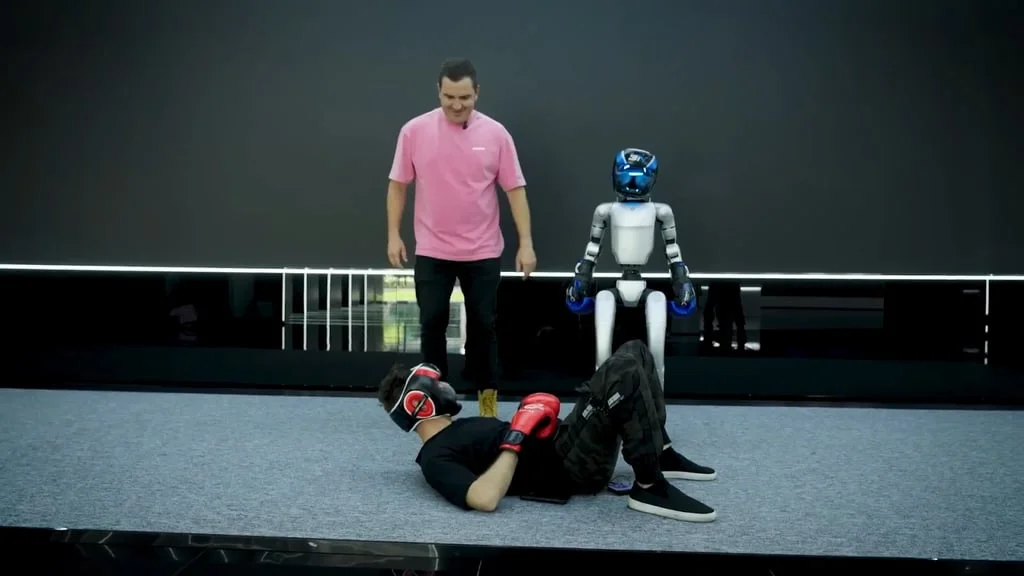 A staged sparring session between a human and a robot where a human seemingly got defeated.